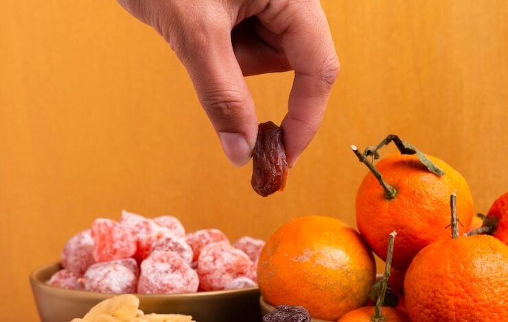 close up hand holding dehydrated fruit chinese new year 23 2148358128