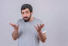 confused young handsome caucasian man showing empty hands isolated white with copy space 141793 77292