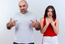 frowning adult couple both looking pointing themselves 141793 57998