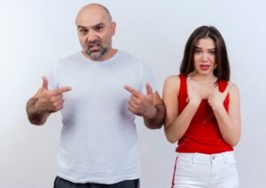 frowning adult couple both looking pointing themselves 141793 57998