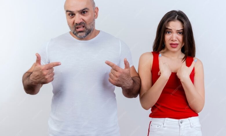 frowning adult couple both looking pointing themselves 141793 57998