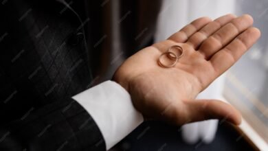 groom holds his palm two wedding rings 8353 10241