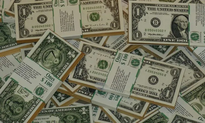 Numerous bundles of US one dollar bills symbolizing wealth, finance, and savings.