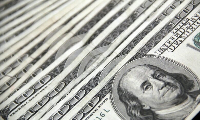 Detailed image showing a close-up of neatly stacked US dollar bills, ideal for financial and economic themes.