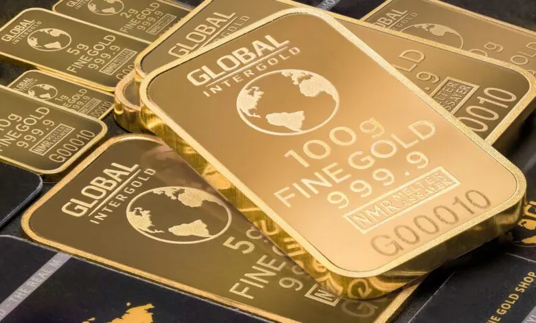 A detailed shot of gold bars labeled 'Global Intergold' as a symbol of wealth and investment.