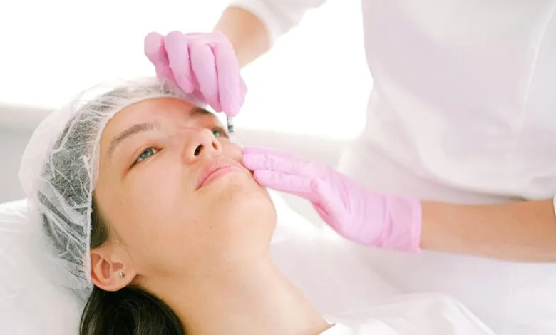 Woman receives cosmetic injection in clinical setting, enhancing beauty using modern techniques.